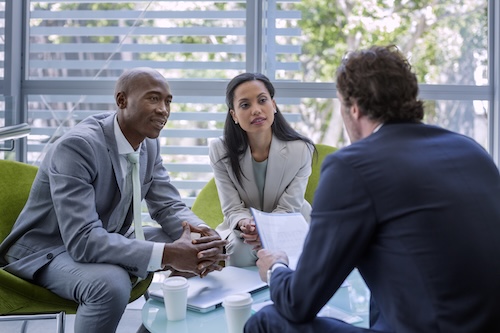Businesspeople with partner explaining strategy